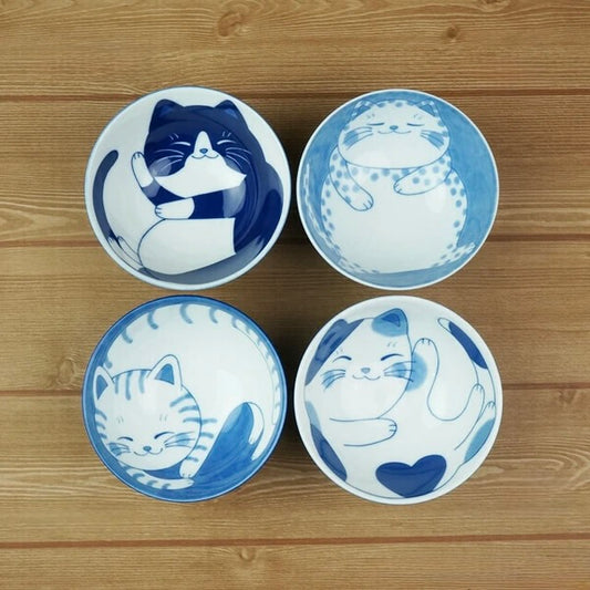 Set of four Nekochigura Mino ware cat bowls featuring blue illustrations of different feline personalities on white ceramic