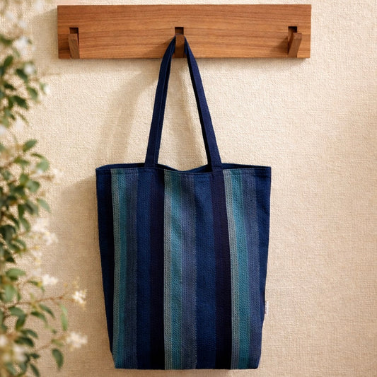 Awa Shijira-ori striped cotton tote bag hanging on wooden hook, lightweight Japanese eco bag made in Tokushima