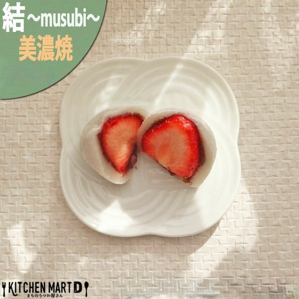 White Musubi small plate with embossed knot motif, served with Japanese sweets