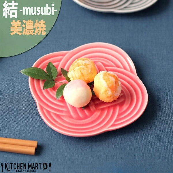 Red Musubi small plate with embossed knot motif, served with Japanese sweets