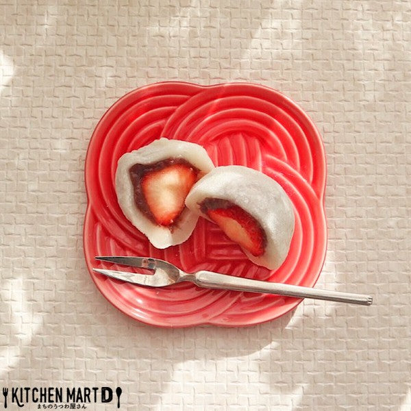 Red Musubi small plate with embossed knot motif, served with Japanese sweets