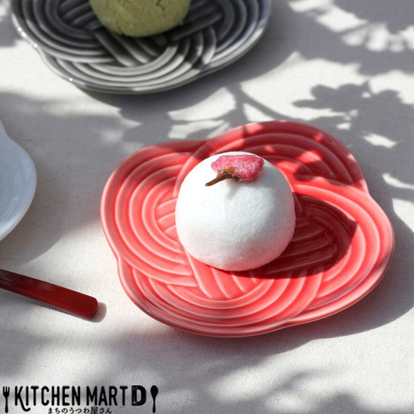 Red Musubi small plate with embossed knot motif, served with Japanese sweets