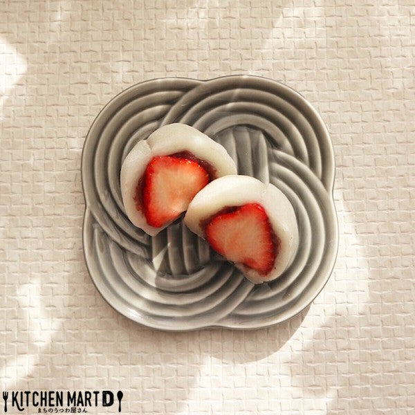 Red Musubi small plate with embossed knot motif, served with Japanese sweets