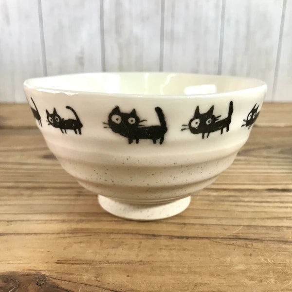 Close-up of black cat motif on Japanese rice bowl, highlighting the detailed artwork

