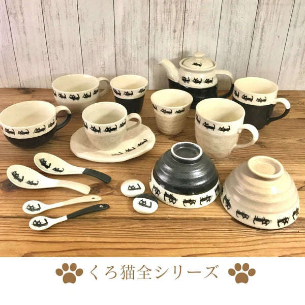 Complete collection of black cat-themed Japanese tableware, including matching bowls and mugs displayed together