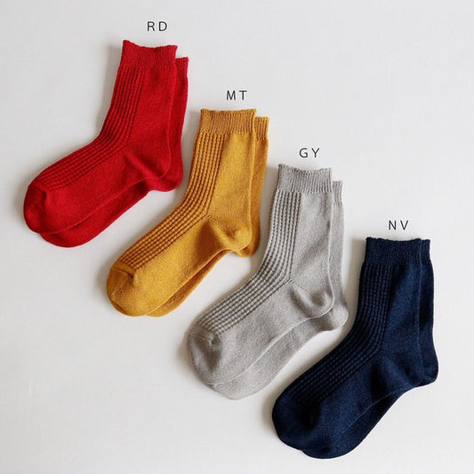A set of four pairs of Washi socks in red, yellow, grey, and navy colors, displayed on a light background.