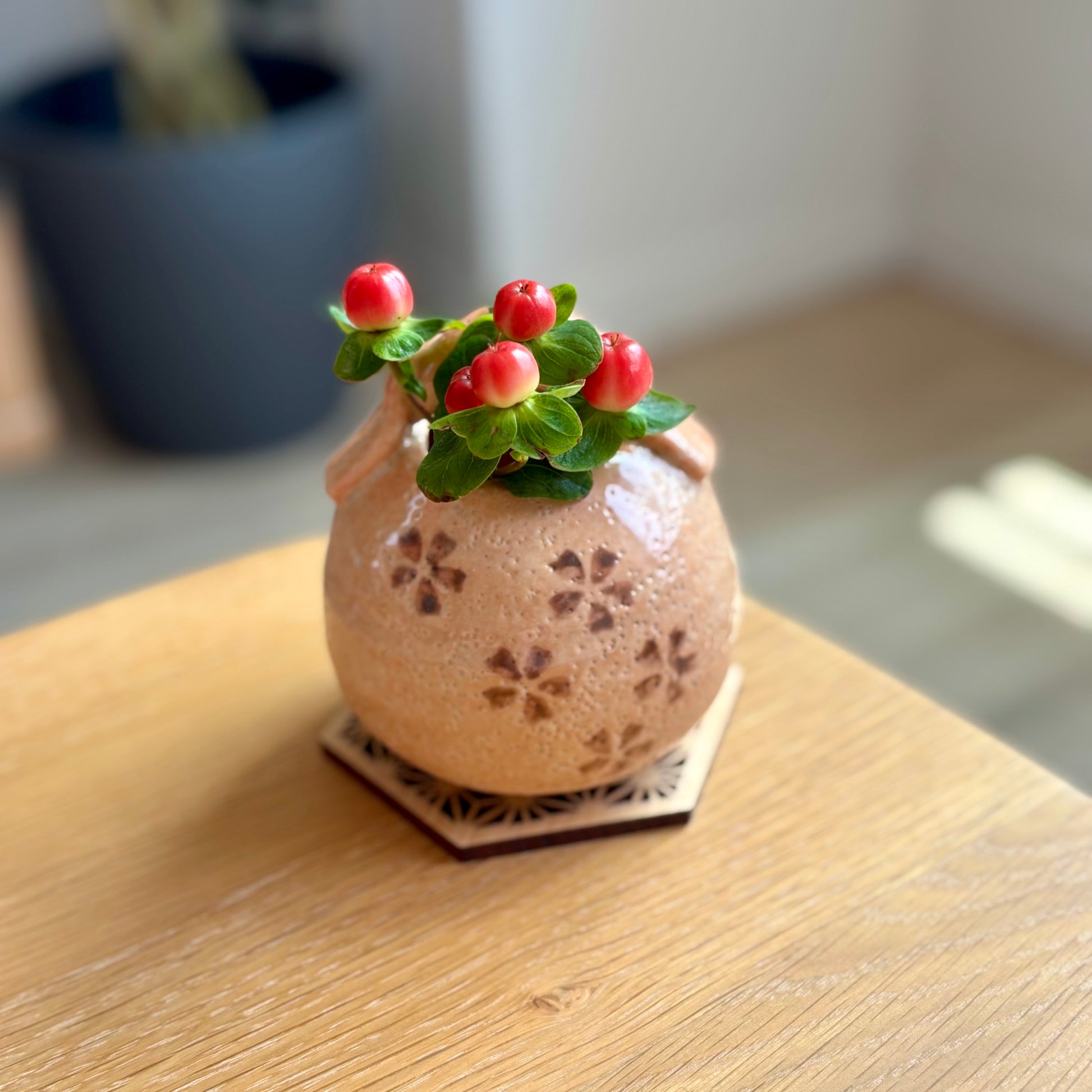 Akashino Sakura vase holding flowers on a wooden table