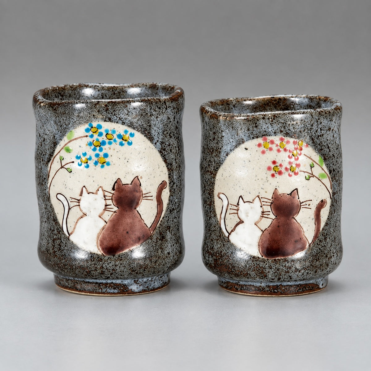 Kutani Ware cat tea cup set with two cups decorated with cats and colorful flowers under a sunny spot